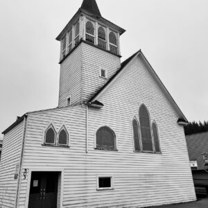 A black and white photo of a church that is over 100 years old